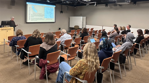 Dr. Margo McBane speaks in LC 129 to an audience of SCU community members on local history.