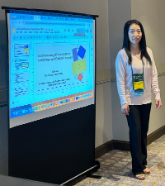 Yujie Ge standing next to he presentationid