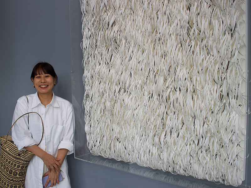 Artist Mia Liu 劉文瑄 in front of a work from her 2022 series Aura.
