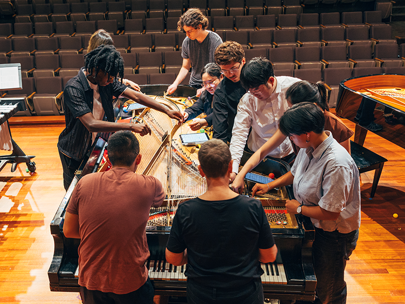 students playing the bowed piano