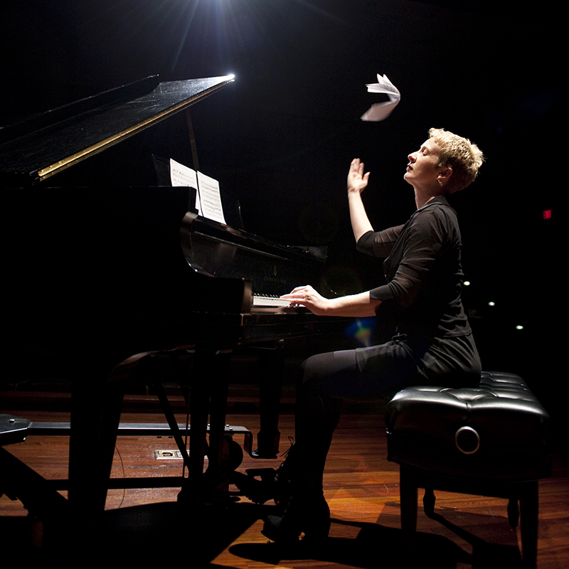 Teresa McCollough at the piano tossing music sheets