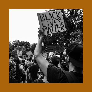 A protester holds a sign reading Black Lives Matter.