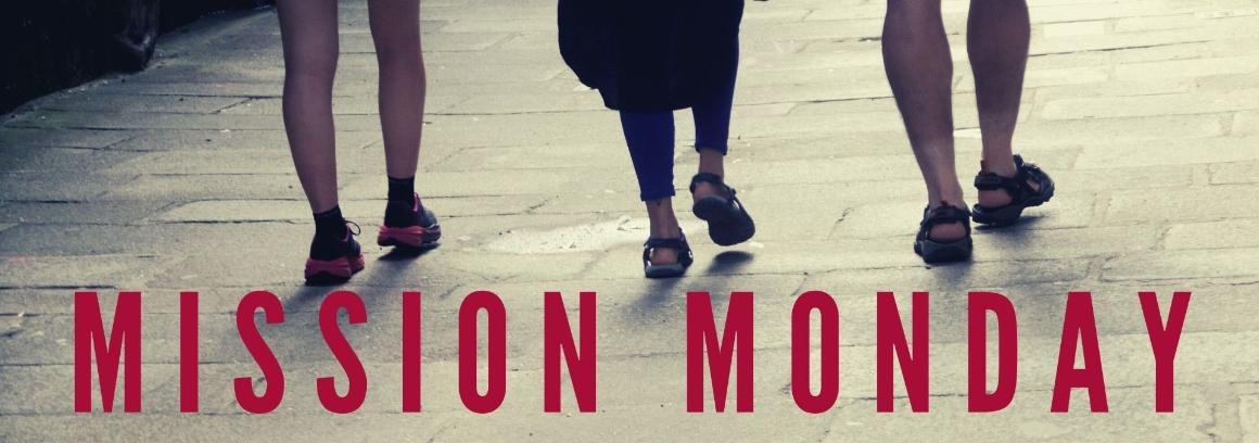 Mission Monday text under three individuals' legs and feet in formal attire.