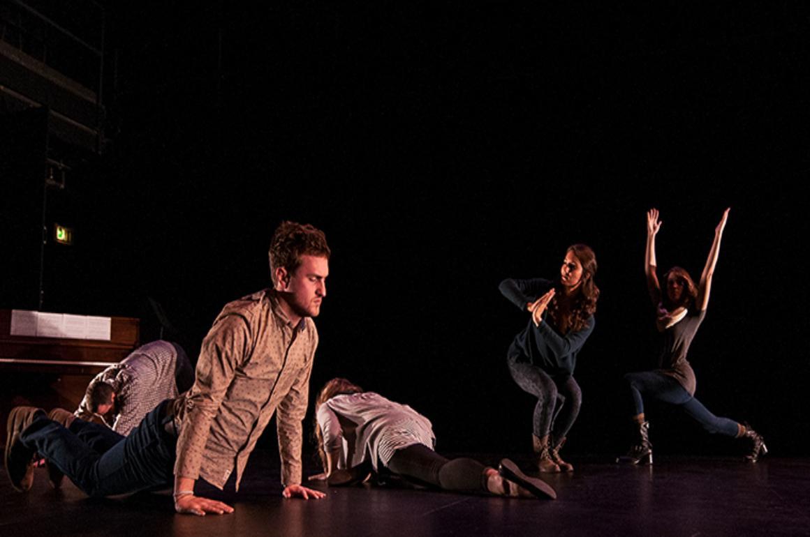Three performers on a dimly lit stage during Charisma 2016.