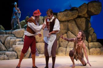 Actors performing a scene from The Tempest on stage.