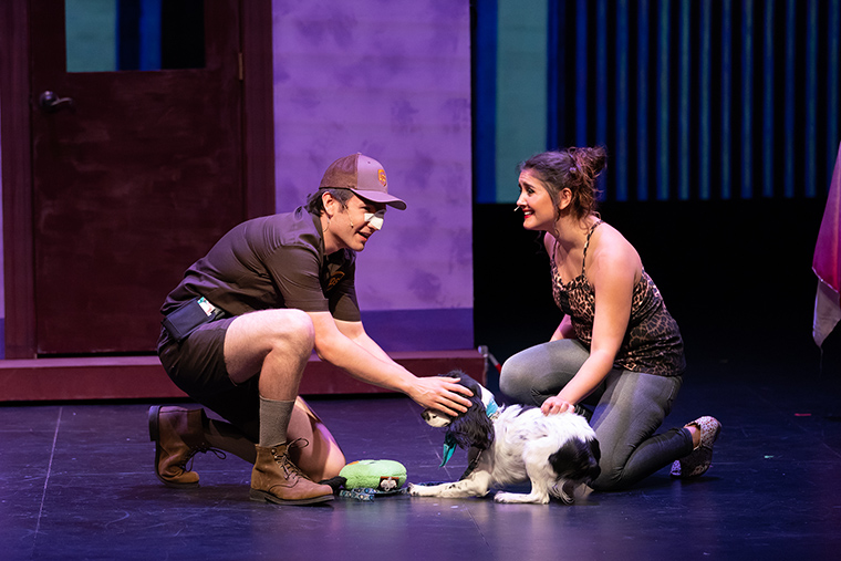 Two actors and a dog performing on stage in Legally Blonde.