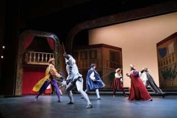 People performing on stage in a scene from Romeo & Juliet.