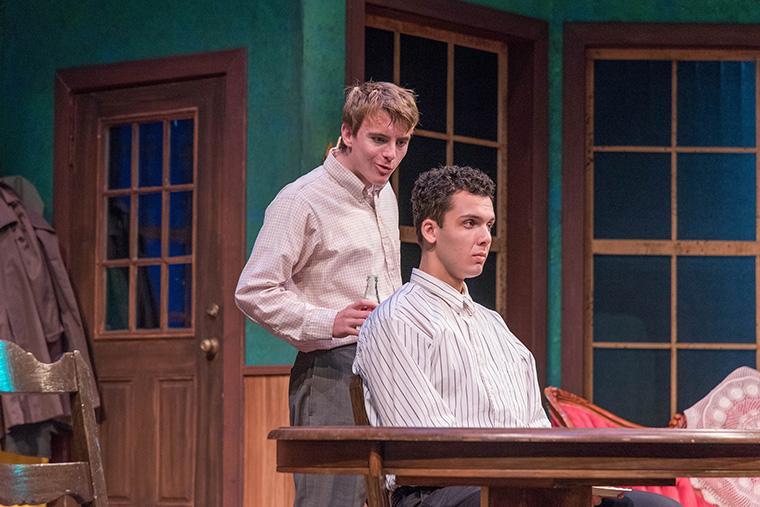 Two actors perform on stage in The Foreigner.