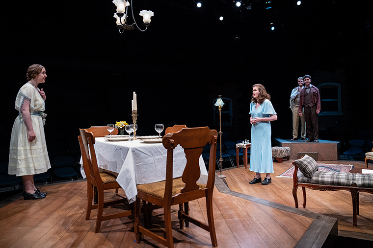 Three actors perform a scene from The Glass Menagerie on stage.