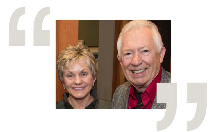 Two smiling individuals, framed by large quotation marks.