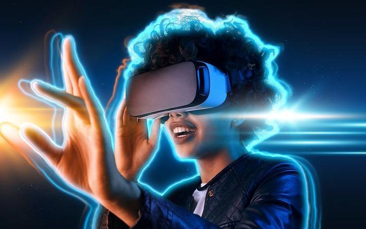 A woman using a VR headset engaging in the metaverse. 