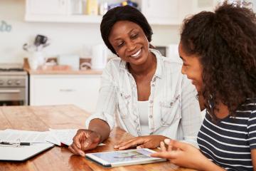 Two people sit at a table, engaging in a positive discussion.