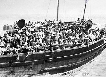 A boat crowded with people at sea.