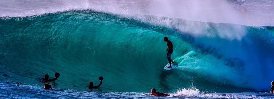 Photo of surfers catching waves  