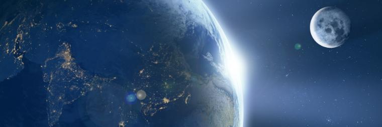 View of Earth from space with the Moon in the background.