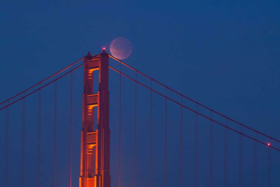 A total lunar eclipse seen over the Golden Gate Bridge is a striking image!