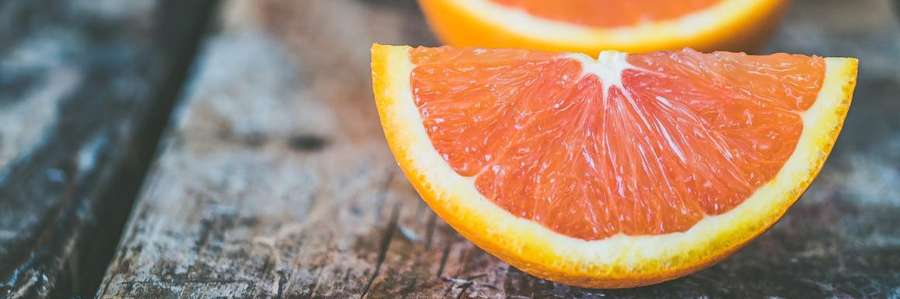 A slice of orange on a wooden table