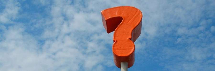 A large red question mark against a blue sky with clouds.