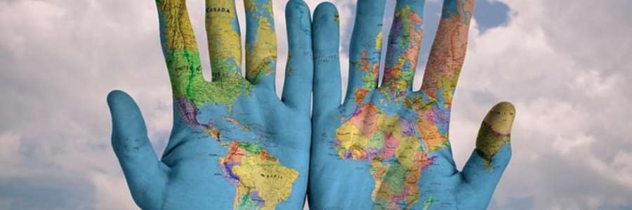 Two hands painted with a world map.