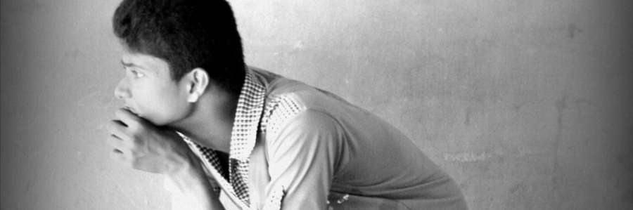 A person looking to the side in a black-and-white photo.