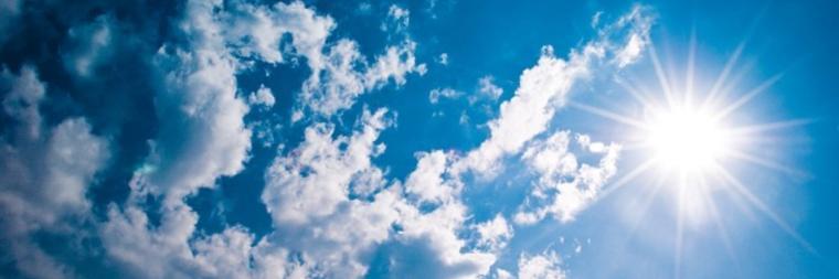 Sunny sky with scattered clouds.