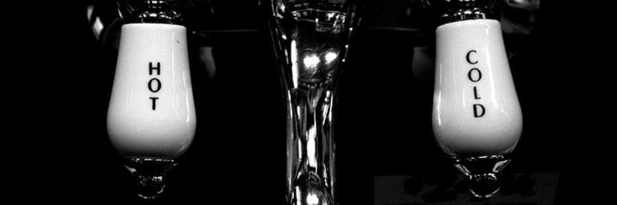 Two vintage light bulbs glowing in a dark setting.