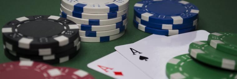 Two Aces and four stacks of different denominations of poker chips