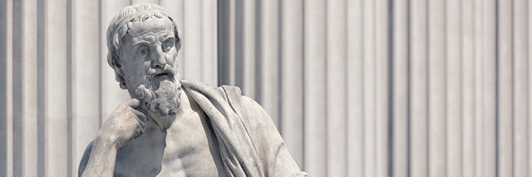 A white marble statue of a thinking man.