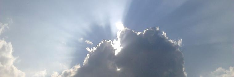 Sunlight breaking through dense clouds in the sky.