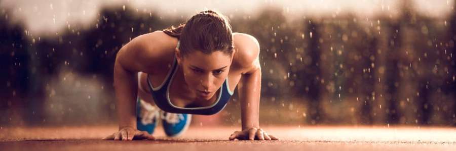 A person doing a plank exercise outdoors.