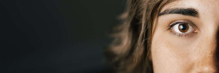 Photo of a woman's face looking into camera.